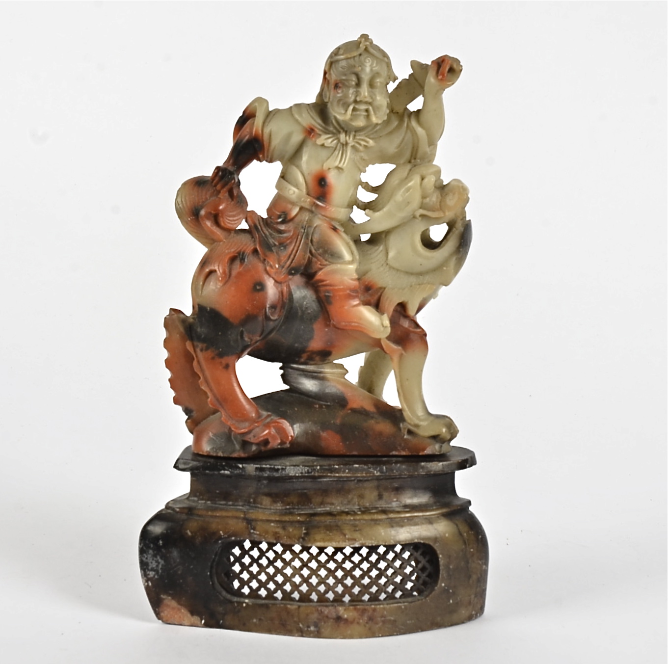 A 19th Century Chinese soapstone carved figure, modelled as a seated warrior upon a mythical