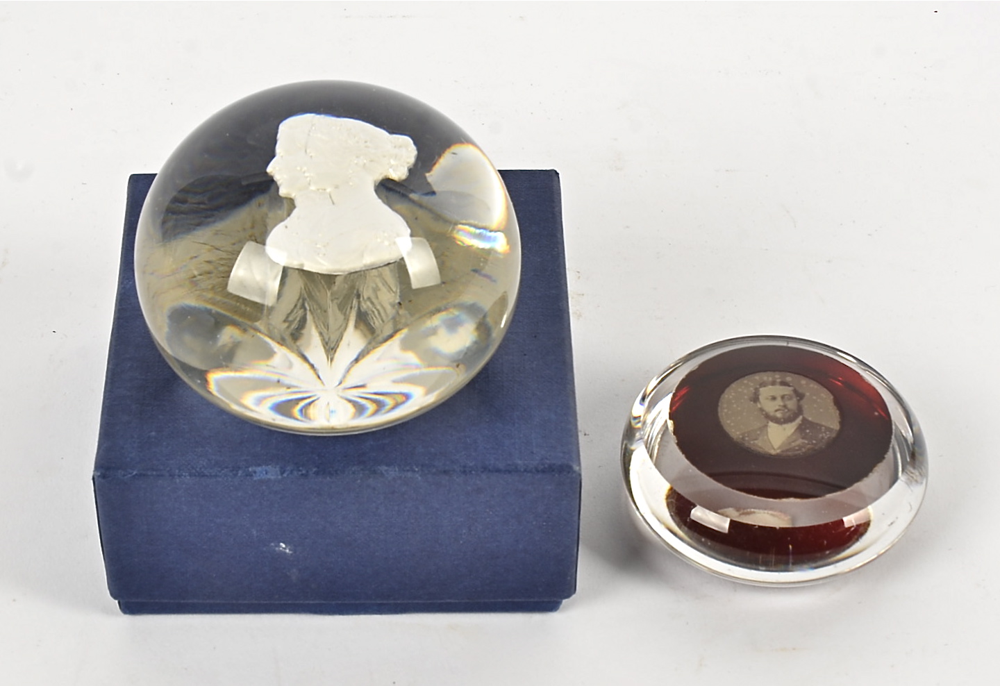 Two Victorian paperweights, one with Victoria and Albert and the other Albert alone, the largest