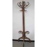 A flat backed bentwood coat and stick stand, 62cm x 204cm