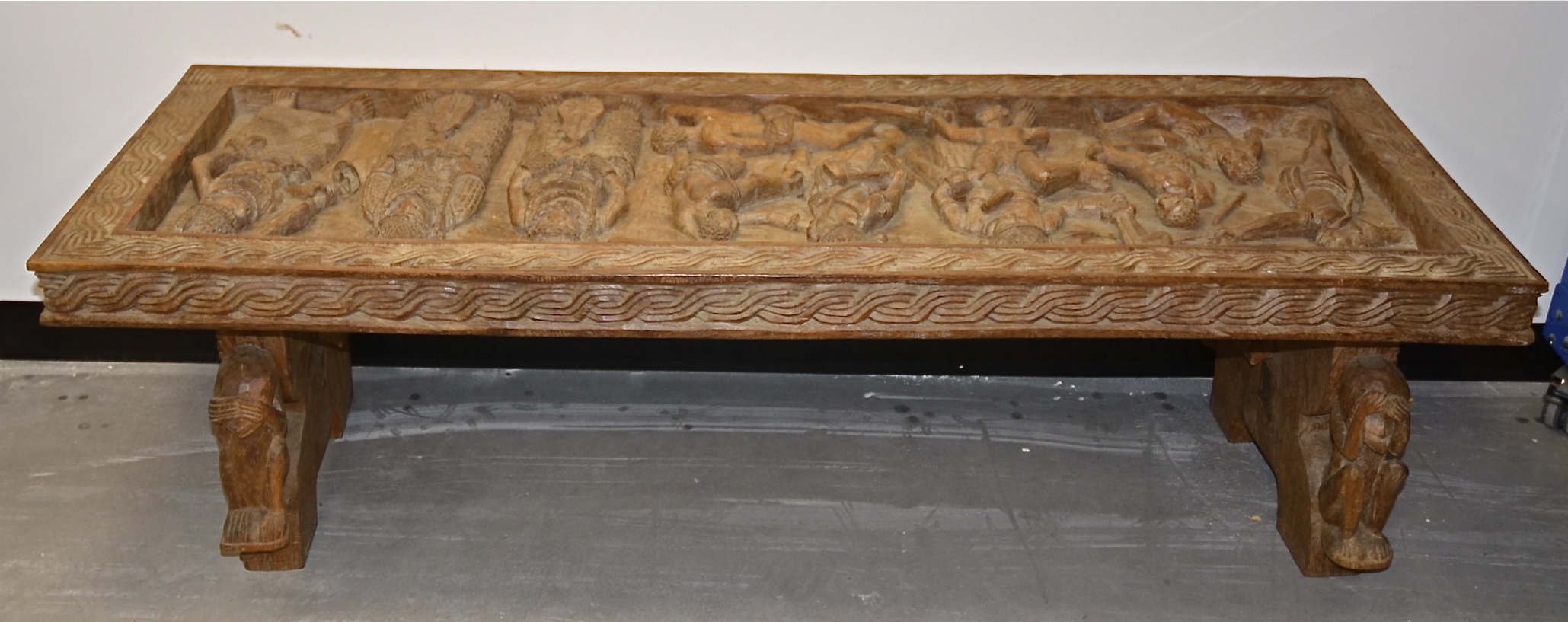 A Benin table and coffer lid, 155cm x 45cm x 52cm, with carved decoration (2)