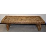 A Benin table and coffer lid, 155cm x 45cm x 52cm, with carved decoration (2)