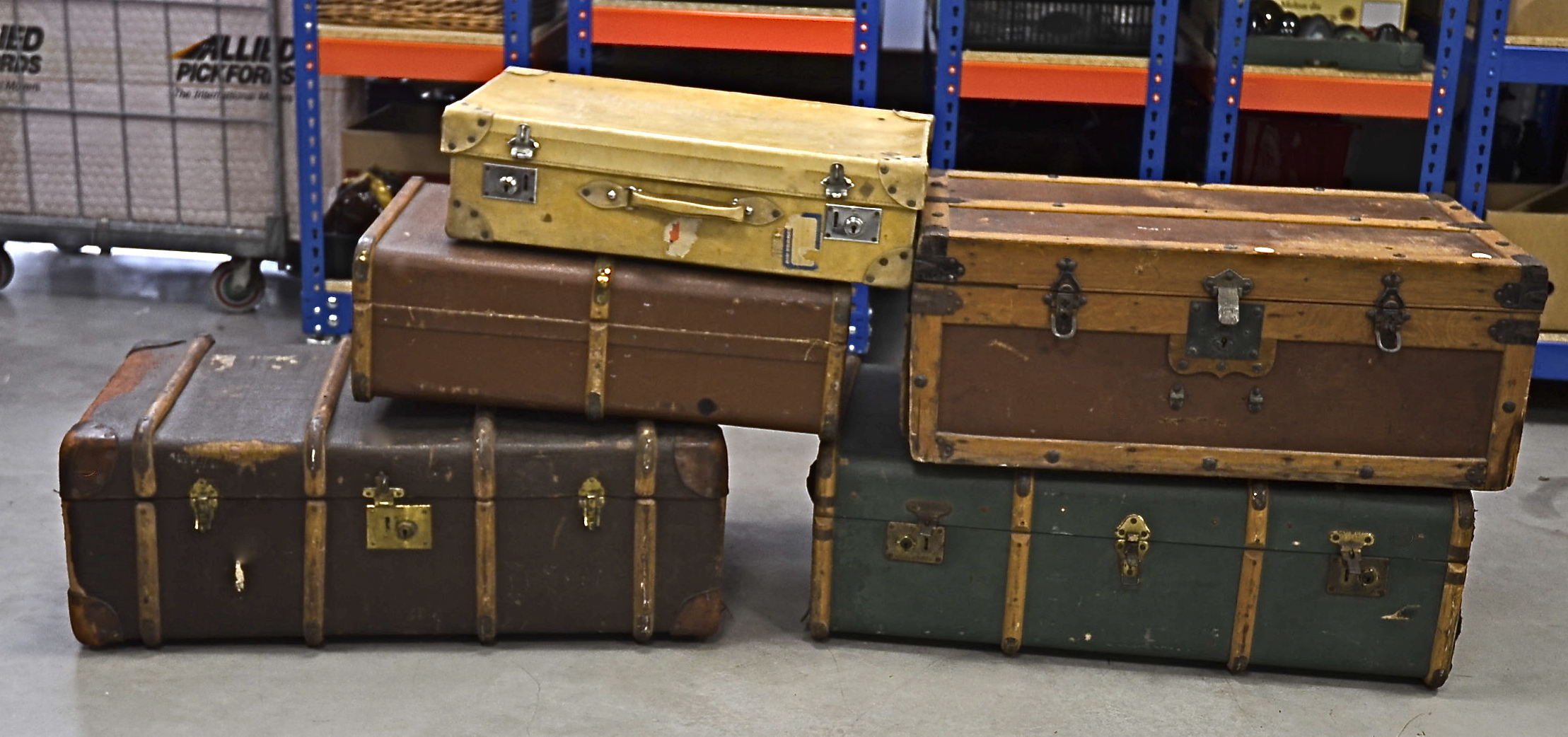 Two large early 20th Century wooden travelling trunks, one with iron binding and side handles,