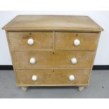 A 19th Century stripped pine chest of drawers, two short drawers over two long drawers, with white