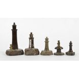 A small group of serpentine stone collectables, taking the form of lighthouses and a toadstool