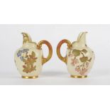 A pair of Royal Worcester flat-back jugs, each with with gold gilt and floral decoration on a