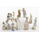 A collection of Lladro and Nao figures, comprising a Lladro 5813 'Having A Ball', 5027 'Flower