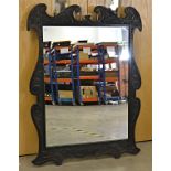 A 20th Century wall mirror, set within a carved wooden frame, 134cm x 97cm