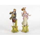 A pair of late 19th Century Volkstedt figures, modelled as a fashionable couple, height 26cm, male