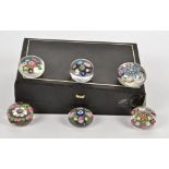 Six small Clichy paperweights, one with concentric millefiori cane decoration taking the form of a