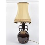 A West German or similar 20th Century pottery lamp, with twin handles, multiple holes and volcanic