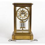 A late 19th Century French brass mantel clock, the 11.5cm white enamel dial with Roman numerals (