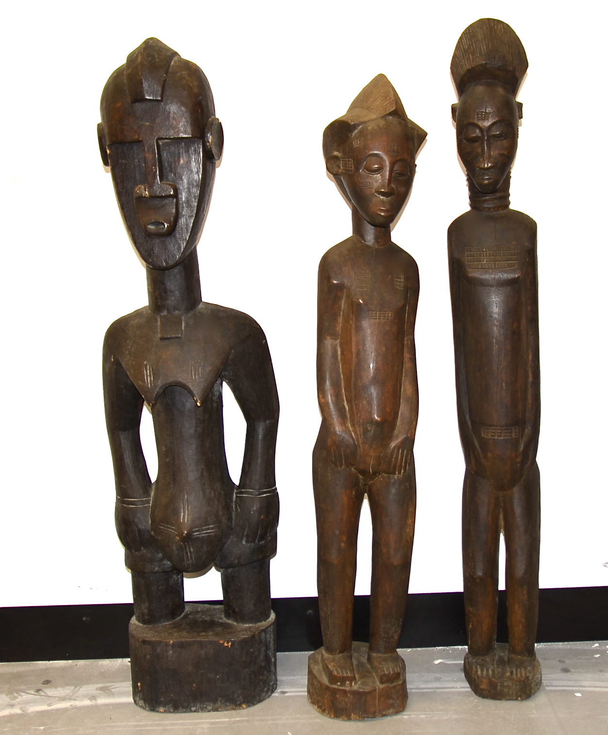 Two Baule figures and a Senufo figure, Ivory Coast, tallest 100cm (3)