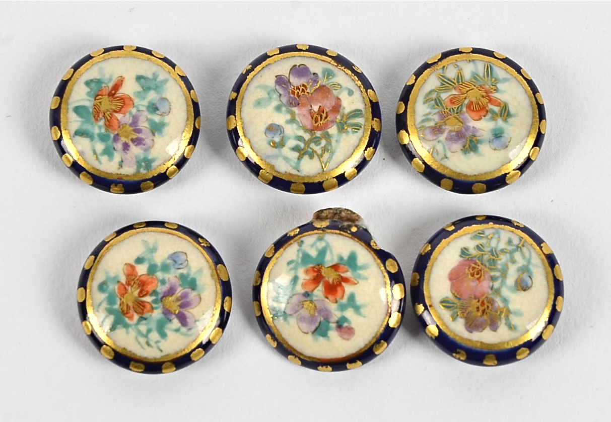 A set of six Japanese Satsuma ware buttons, each with handpainted flowers on a cream ground (6)