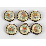 A set of six Japanese Satsuma ware buttons, each with handpainted flowers on a cream ground (6)