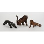 Three early 20th Century Asian boxwood and composite animal figures, two lions and one panther,