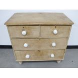 A 19th Century stripped pine chest of drawers, two short drawers over two long drawers, with white