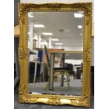 A contemporary swept gilt frame mirror, with bevelled plate, 109cm x 79cm