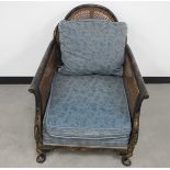 A 1920's cane chinoiserie armchair, ebonised on a mahogany frame with coloured painted details and