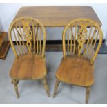 A small oak refectory table, shaped end supports and shaped peg stretcher, sold together with a pair