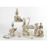 A small collection of Lladro porcelain figures, including a boxed example of a girl holding ducks,