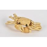 A Japanese Meiji period okimono ivory study of a crab, with connected limbs and claws, and