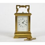 A late 19th Century French brass carriage clock, white enamel dial with Roman numerals, inscribed '
