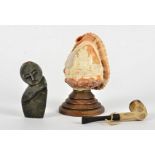 A carved cameo conch shell with imagery of the Christian Ave Maria, mounted upon a wooden base,