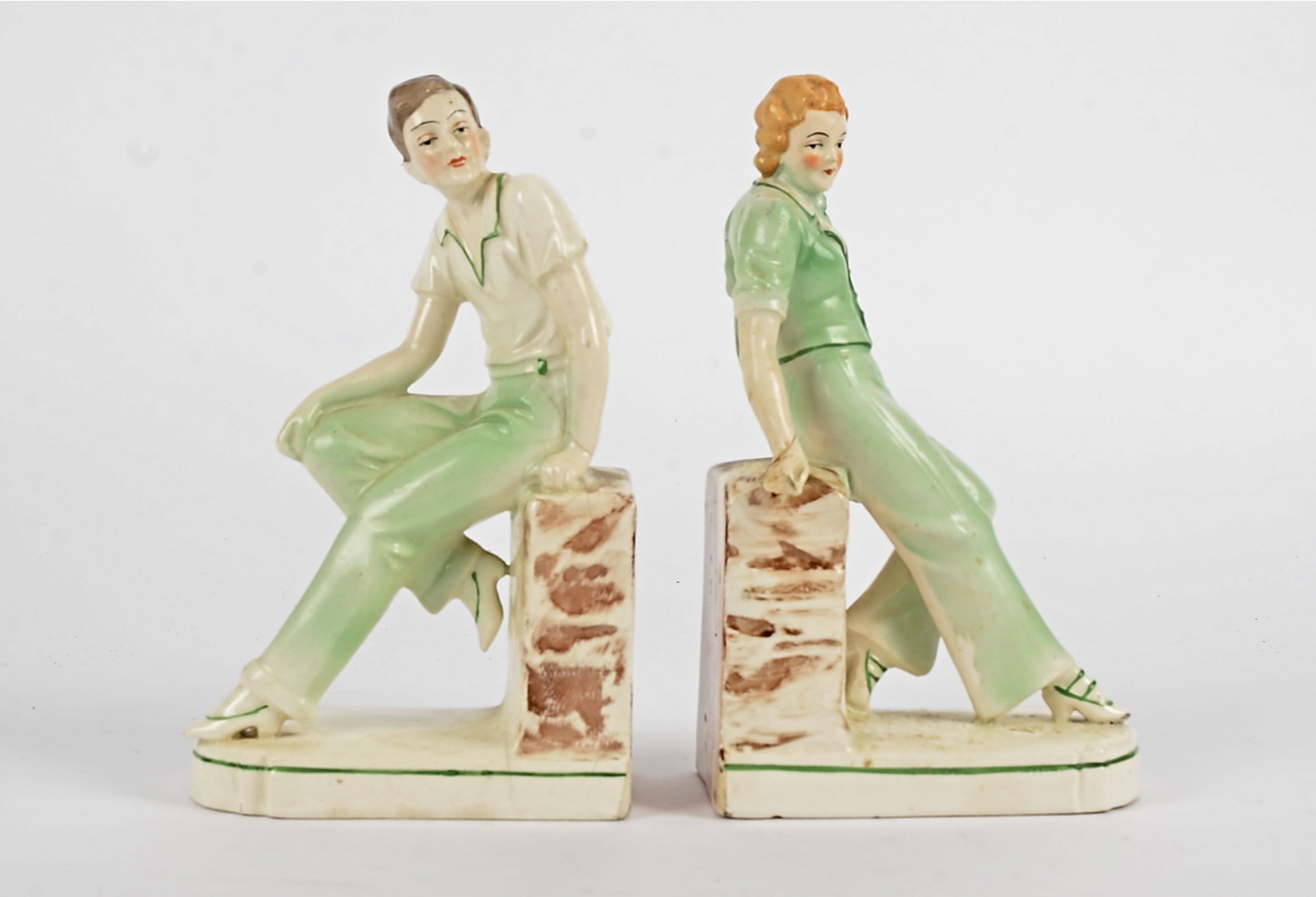 A pair of early 20th Century bookends, taking the form of youthful male and female companions,