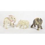 Three porcelain elephants, one a grey Nymphenburg study, height 11.5cm, together with another