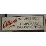 A large mid 20th Century wooden painted sign for Allans stating 'We apologise for temporary