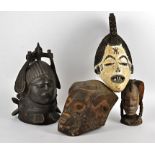 A collection of African masks, to include a Igbo maiden spirit mask, a Kuba mask, Makonde mask,