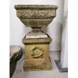 A large stone garden ornament, height 95cm, the graduated open square top raised on a plinth with