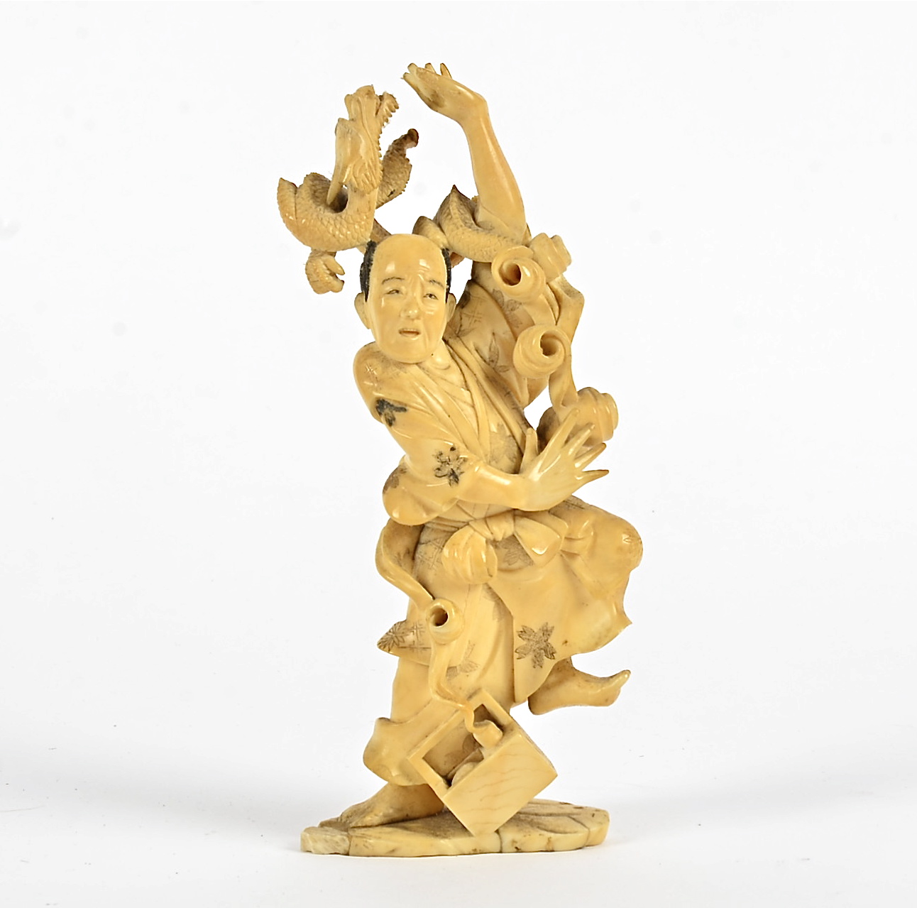 A Japanese Meiji period okimono of a magician and his dragon, height 17cm, artist's signature to