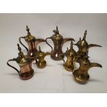 Arabic Dallah Coffee Pots, a group of copper and brass Dallah some with decorative detail in varying