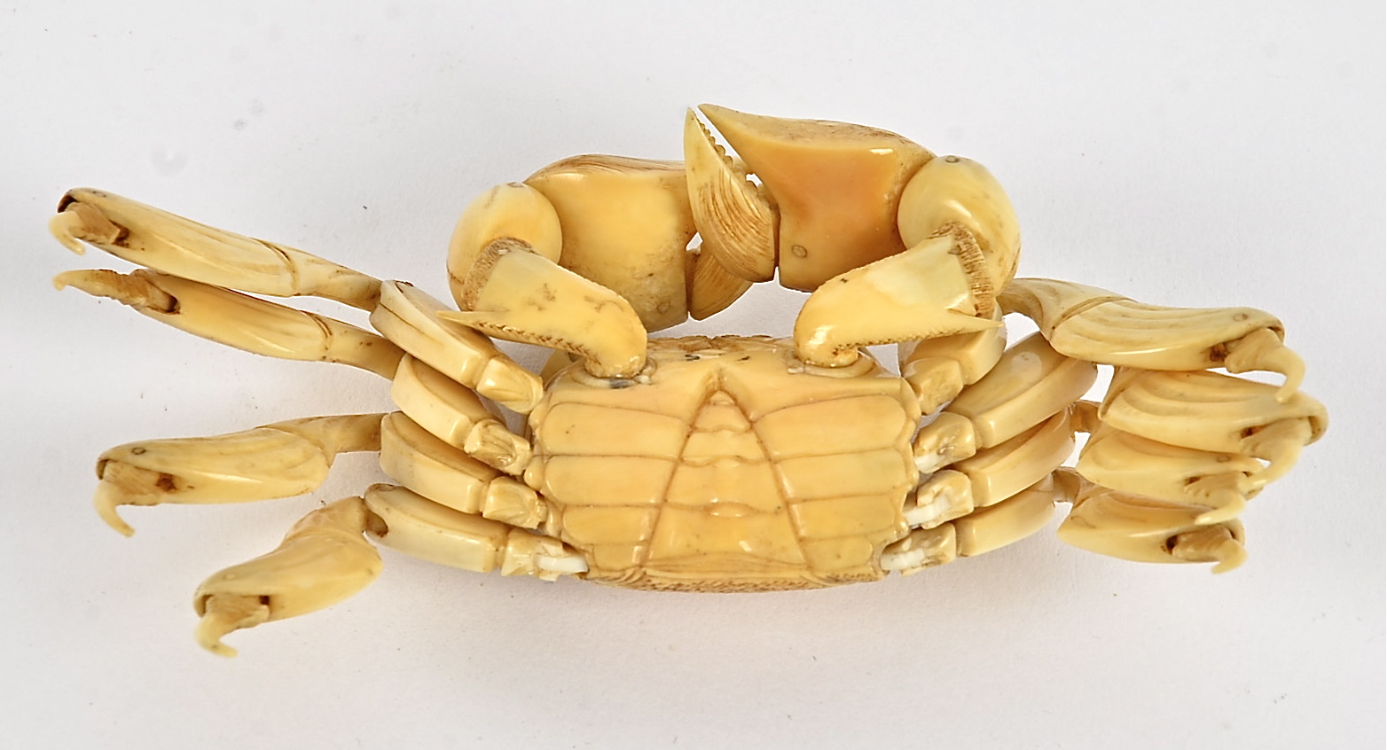 A Japanese Meiji period okimono ivory study of a crab, with connected limbs and claws, and - Image 2 of 2