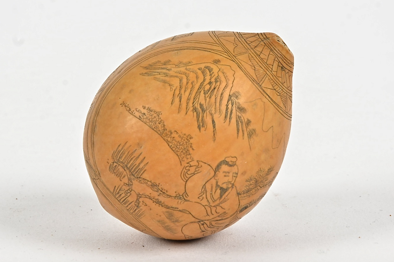 A Chinese gourd with profusely carved decoration, showing a pair of figures in a mountainous