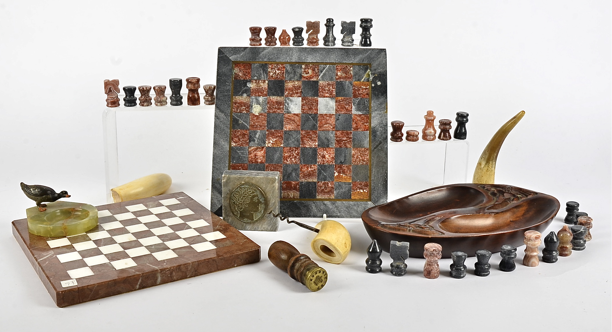 Two marble chess boards, together with a small quantity of chess pieces, but not a full set, a