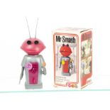 A Marx Toys Plastic Clockwork Mr Smash Walking Martian, grey body, pink head and chest panel, silver