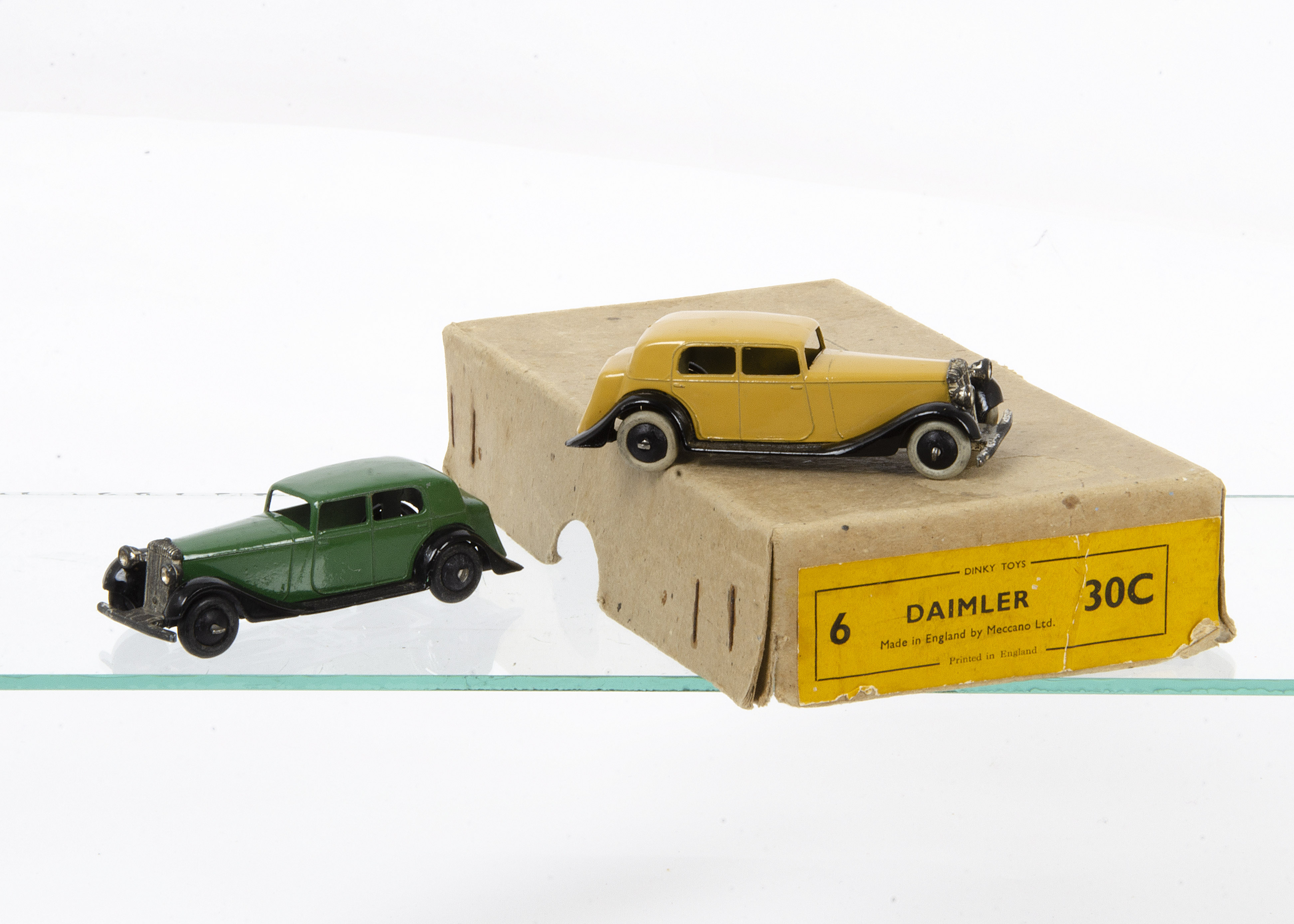 Dinky Toys 30c Daimler, two examples, first pale tan body, black open chassis, smooth hubs, white