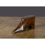 A 19th Century carved wooden shoe snuff box, with pin decoration to front and sole, sliding lid —