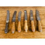 Six bread knives, five wooden-handled, carved with grapevines, wheat sheafs and acorn; and one