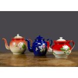 Three enamel teapots, one red and white decorated with a water lily —6¼in.(16cm.) high; and