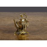 A kettle on stand tape measure, brass and tinplate —2in. (5cm.) high