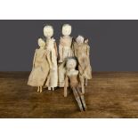 Five pegged wooden dolls, probably early 20th Century with painted features, peg jointed limbs and