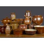 Fourteen brown glazed stoneware cooking pots and vessels, including a jug with banding —10in. (25.