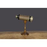 A late 19th Century kaleidoscope, gold lacquered tinplate barrel with ebonised and brass ends,