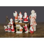 Bisque Father Christmas cake decorations, eleven standing Father Christmas, the largest — 6in. (