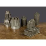 Six British tinplate moulds, two architectural jelly moulds —8½in. (21.5cm.) largest; ice cream or