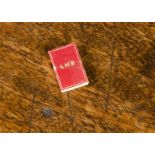 A Queen Mary’s Dolls’ House LMS train time table, with red cover —1in. (2.5cm.) high (slight