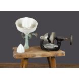 Two fruit juicers, a German cast-iron table top squeezer painted pale blue with pottery bowl,